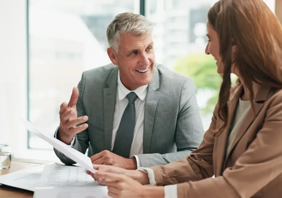 Businessman and woman discussing documents.